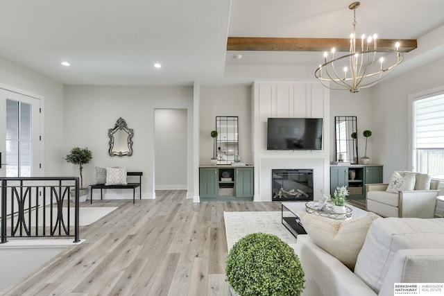 living room featuring a chandelier, beam ceiling, and light hardwood / wood-style floors