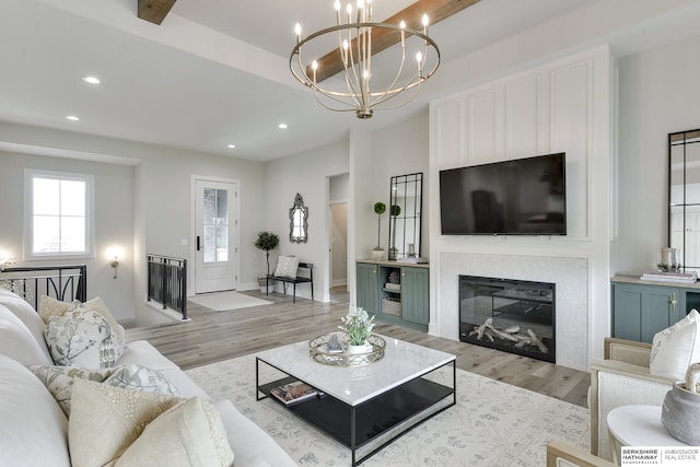 living room with a chandelier and light hardwood / wood-style floors