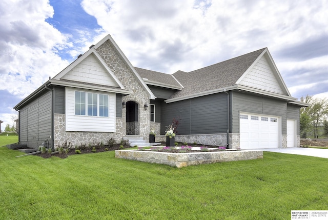 view of front of home with a front yard and a garage