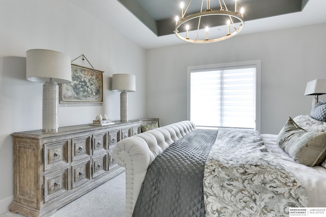 bedroom featuring light carpet and an inviting chandelier