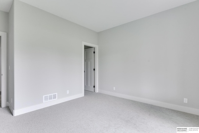 unfurnished room with light carpet