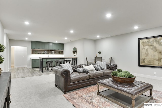 carpeted living room with sink