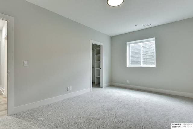 unfurnished room featuring light carpet