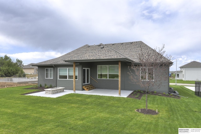 back of house with a lawn and a patio