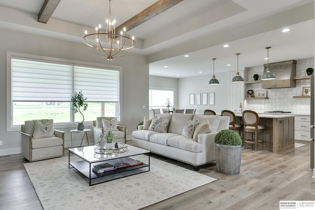 living room with beamed ceiling, light wood-type flooring, and a notable chandelier