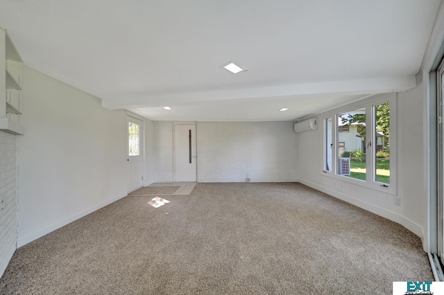 unfurnished room with an AC wall unit, carpet floors, brick wall, and beam ceiling