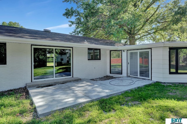 back of house with a patio area and a yard