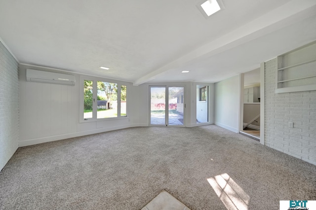 carpeted empty room with built in shelves, a wall mounted AC, and beam ceiling