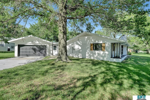 ranch-style house featuring a garage and a front lawn