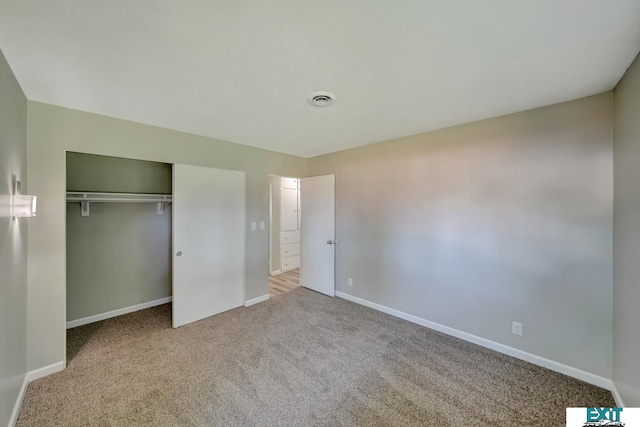 unfurnished bedroom with a closet and carpet