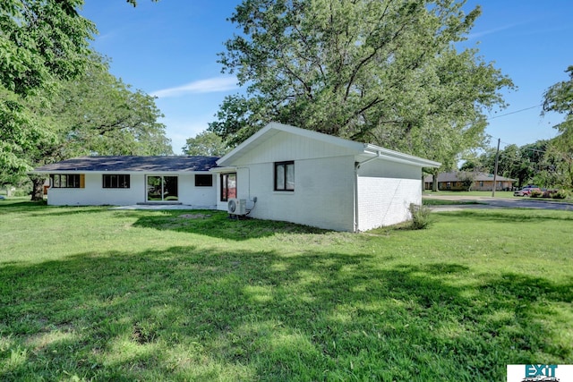 back of property with a lawn