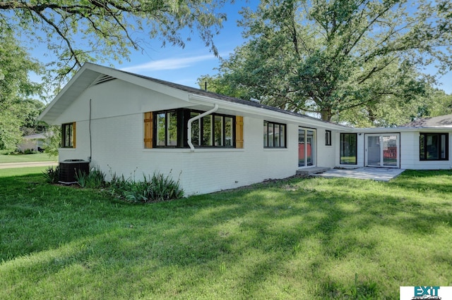 rear view of house featuring central AC, a yard, and a patio