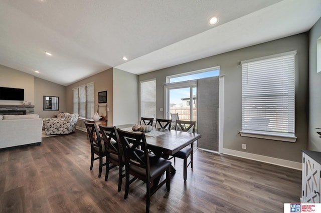 dining area with dark hardwood / wood-style floors and lofted ceiling