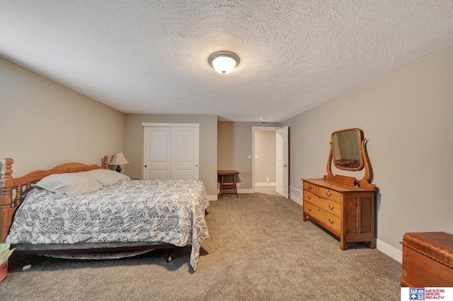 carpeted bedroom featuring a textured ceiling and a closet