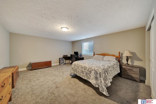 bedroom featuring carpet flooring and a textured ceiling