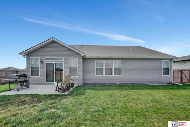 rear view of house featuring a patio and a lawn