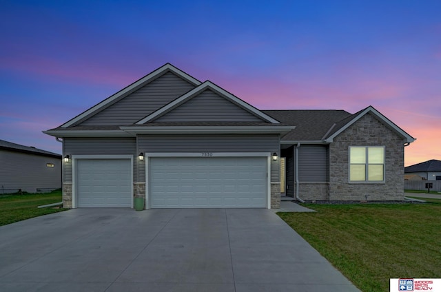 view of front of home featuring a lawn and a garage