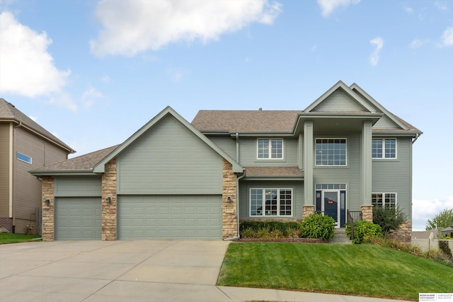 view of front of home featuring a garage and a front lawn