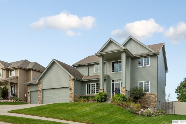 craftsman inspired home with a garage and a front lawn