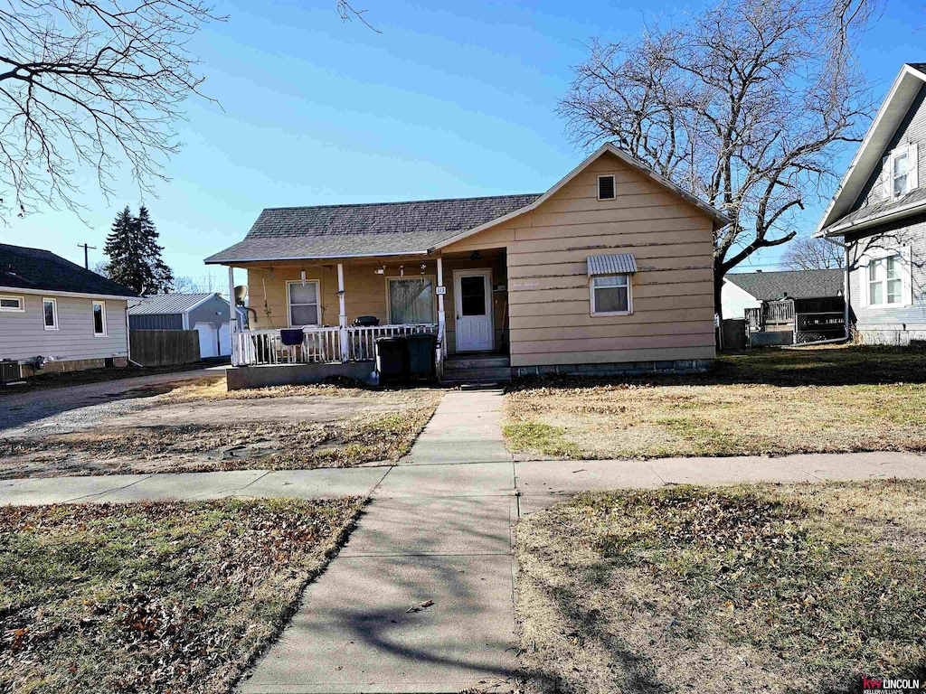 bungalow-style home featuring a front yard and a porch