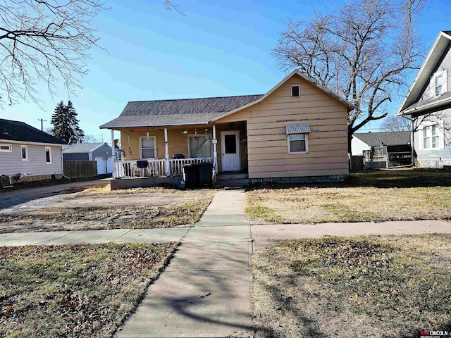 bungalow-style home featuring a front yard and a porch