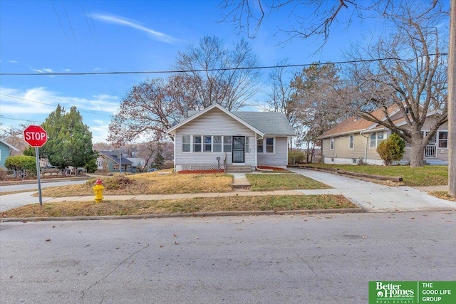 bungalow-style house with a front lawn