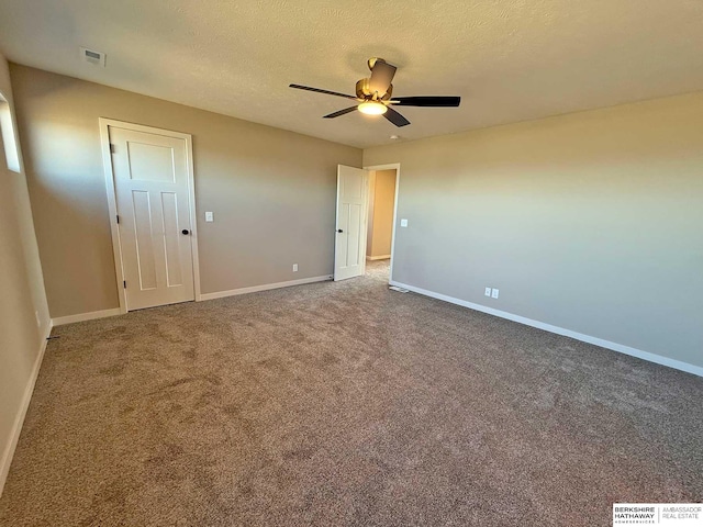 unfurnished bedroom with ceiling fan, carpet, and a textured ceiling