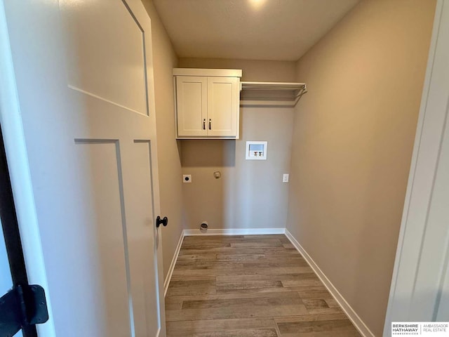 clothes washing area with hookup for a washing machine, light hardwood / wood-style flooring, cabinets, and hookup for an electric dryer