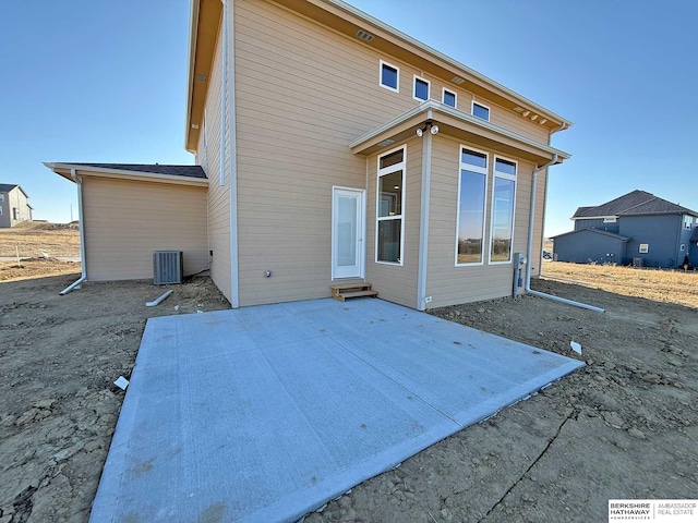 rear view of property with a patio area and central air condition unit