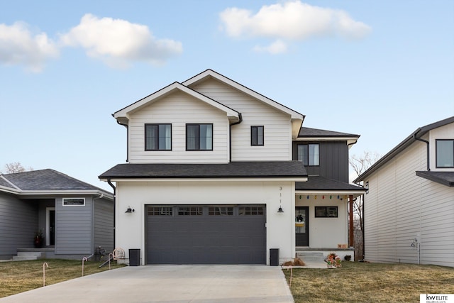 view of front of home featuring a garage and a front lawn