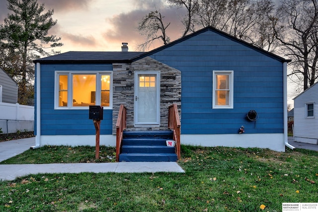 view of front of property with a yard