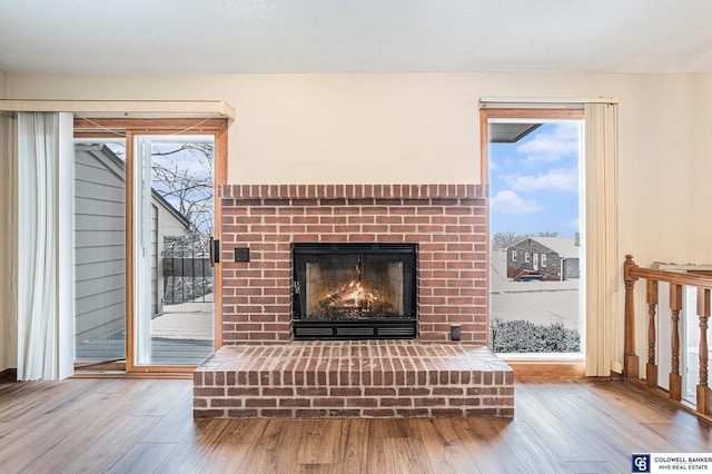 unfurnished living room with a fireplace and wood-type flooring