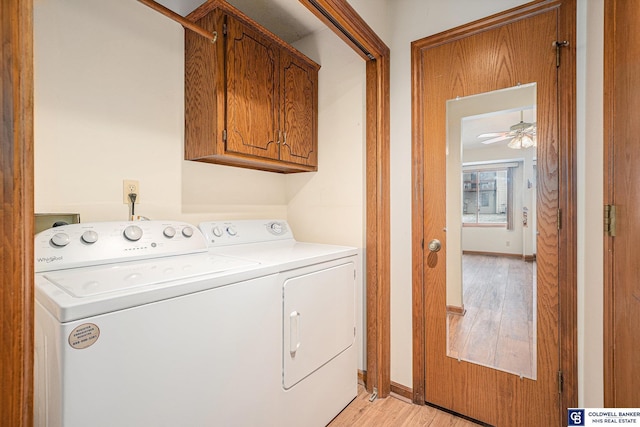 laundry room with cabinets, washing machine and dryer, light hardwood / wood-style floors, and ceiling fan