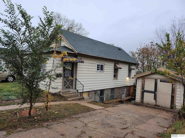 view of front of house with a storage shed