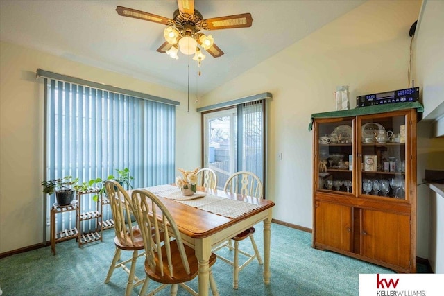 carpeted dining space featuring ceiling fan and lofted ceiling