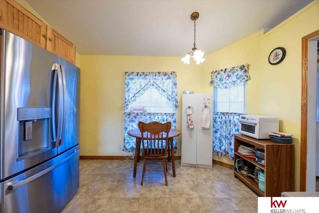 dining area featuring an inviting chandelier