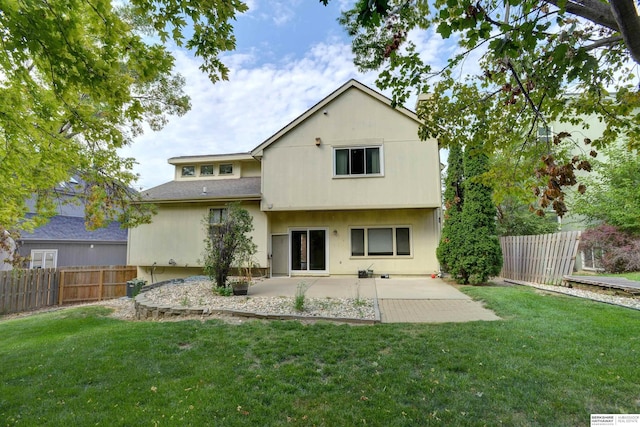 rear view of property featuring a yard and a patio