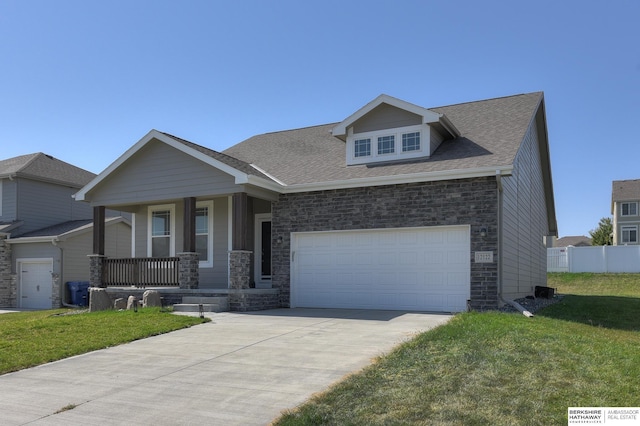 craftsman-style home with a front lawn, a porch, and a garage