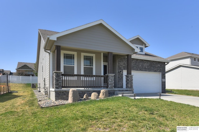 view of front of home featuring central AC, a front lawn, a porch, and a garage