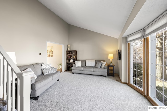 living room with lofted ceiling and carpet floors