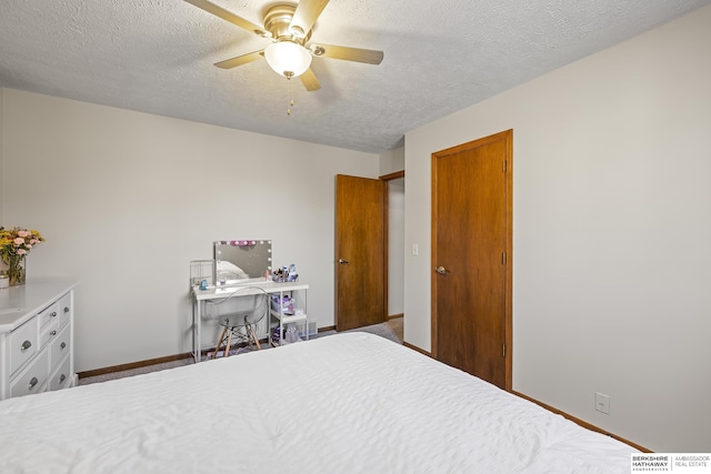 bedroom with a textured ceiling and ceiling fan