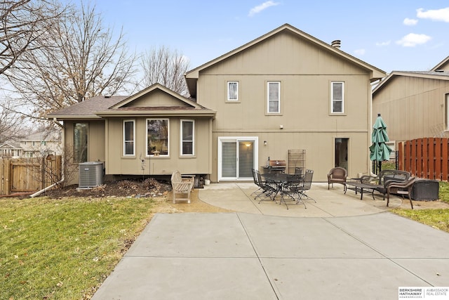 back of property featuring a lawn, central air condition unit, and a patio