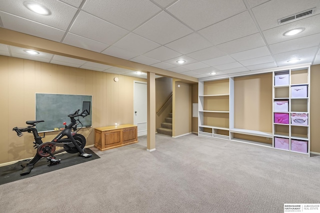 exercise area with a paneled ceiling and carpet floors