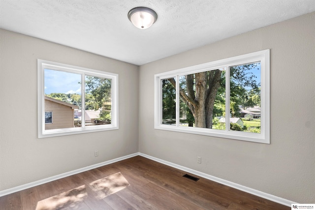 empty room with hardwood / wood-style floors