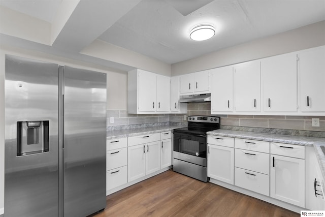 kitchen featuring white cabinets, appliances with stainless steel finishes, dark hardwood / wood-style floors, and decorative backsplash