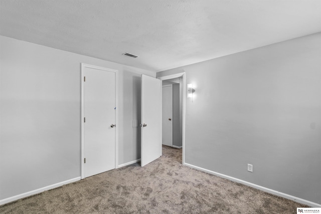 unfurnished bedroom with light colored carpet