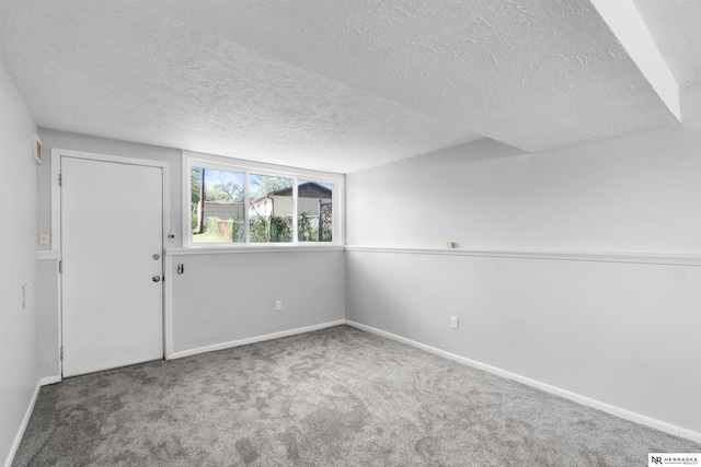 spare room with carpet floors and a textured ceiling