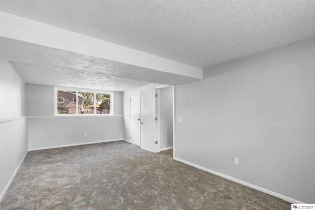 carpeted spare room featuring a textured ceiling