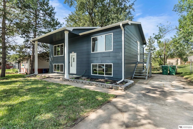 raised ranch with a front yard