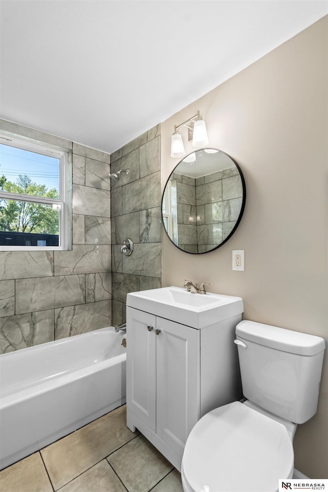 full bathroom with tile patterned floors, toilet, vanity, and tiled shower / bath